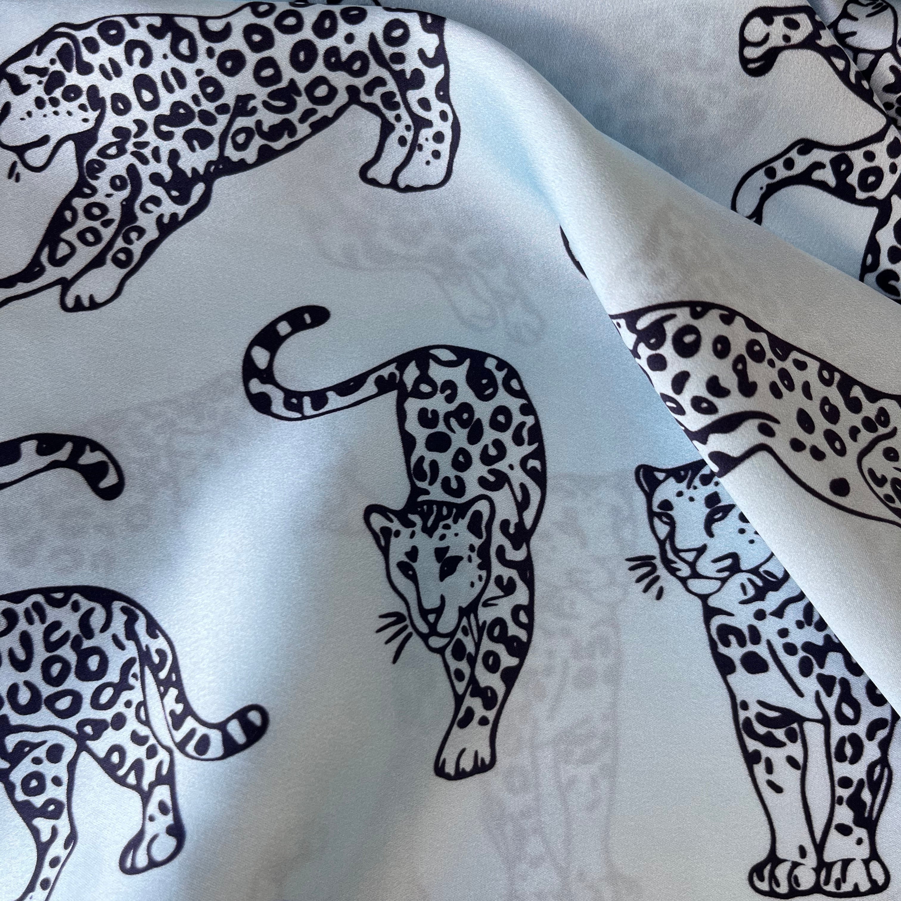 Light Blue MYRN Silk fabric with dark blue leopard printed on it