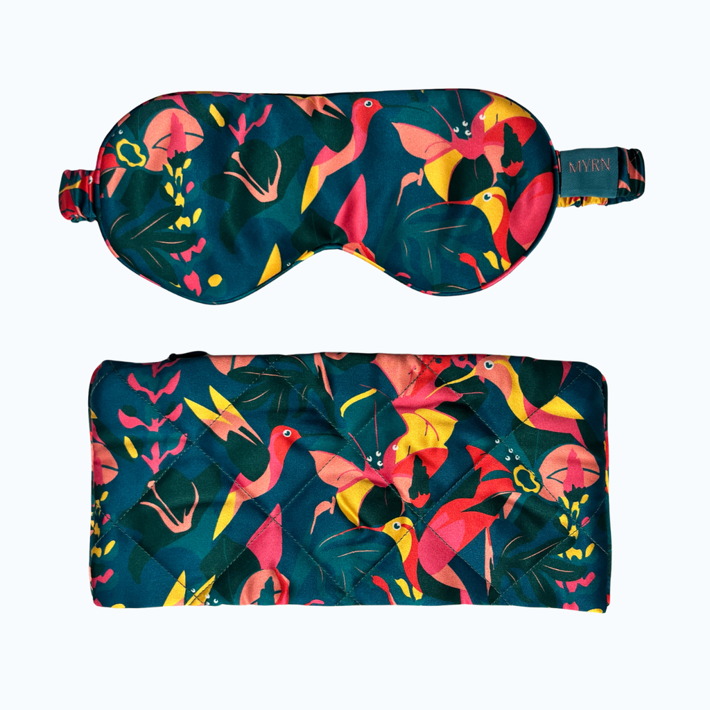 Product shot of lively hummingbird silk eye mask and travel case on a white background