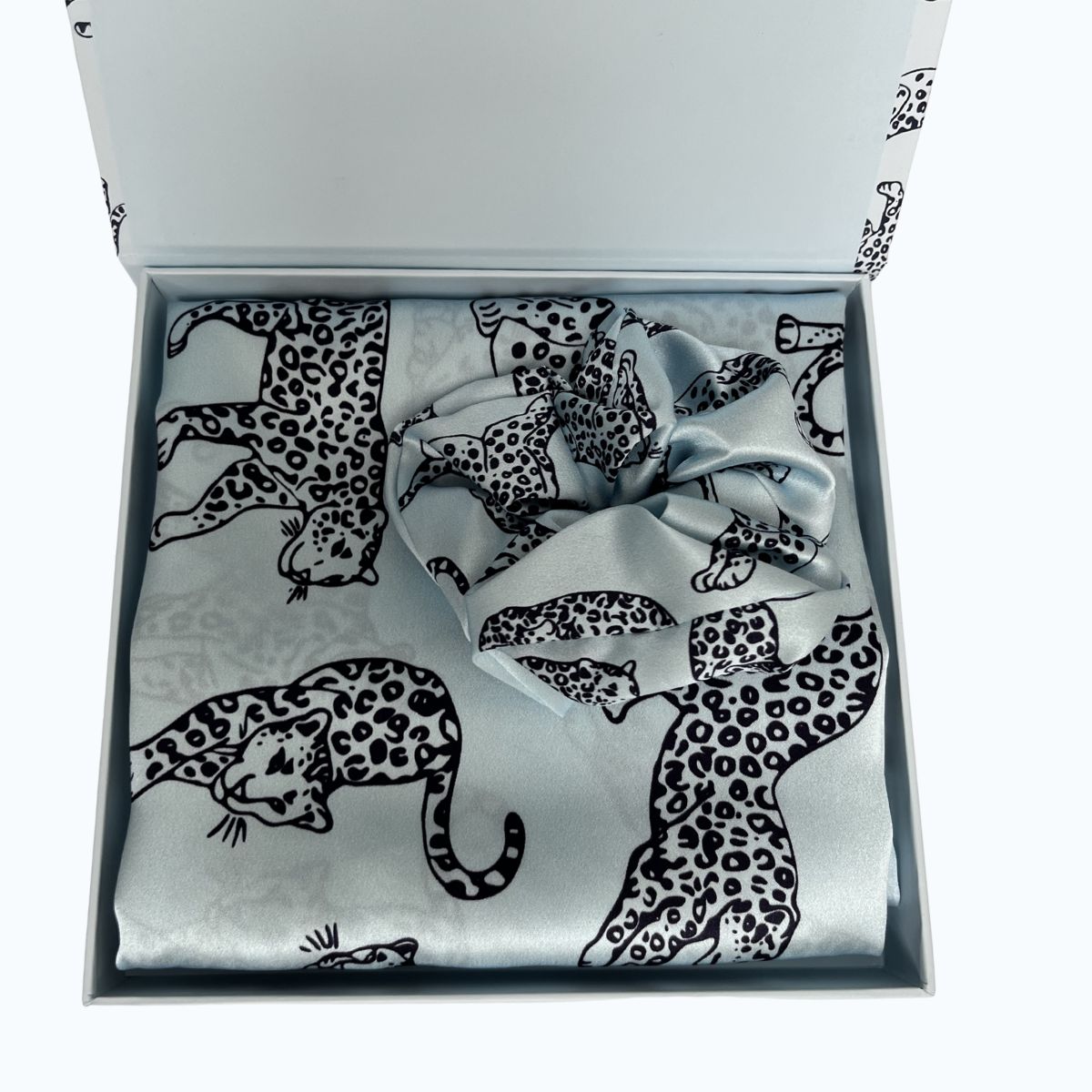 MYRN Blue Leopard Silk Pillowcase in a box with a matching large silk scrunchie on a white background