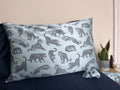 MYRN Blue Leopard Printed silk pillowcase and matching scrunchie on a bed