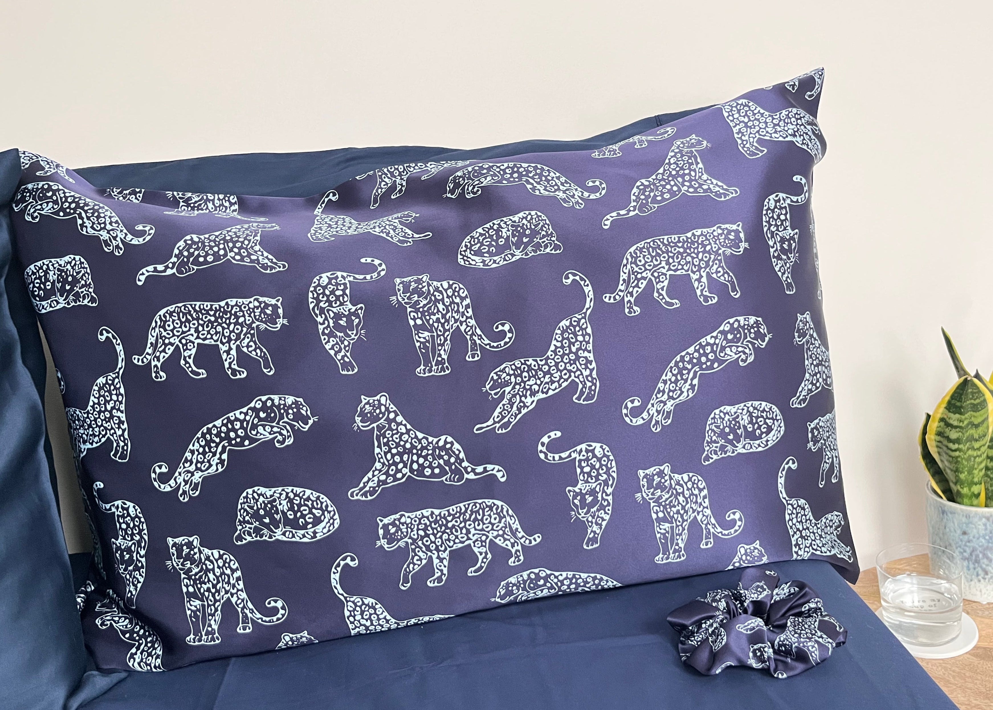 MYRN Midnight Blue silk pillowcase and large silk scrunchie on a bed