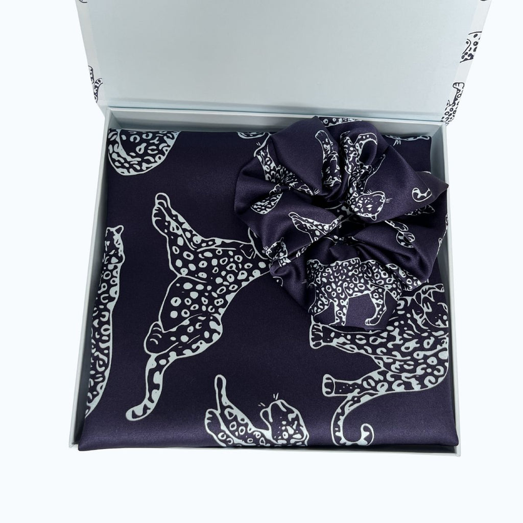 MYRN Midnight Blue leopard printed silk pillowcase and scrunchie in a presentation box on a white background