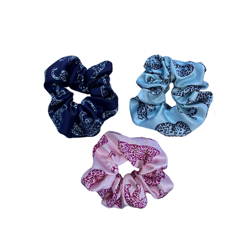 3 coloured leopard printed silk scrunchies on a white background